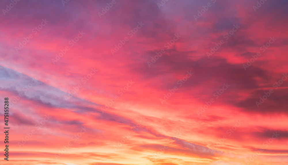 Sunset with a colorful sky in orange, yellow, purple and pink, Horizon twilight in the evening with a beautiful dusk sky sunlight in Winter at countryside,Image Nature for Holiday banner background
