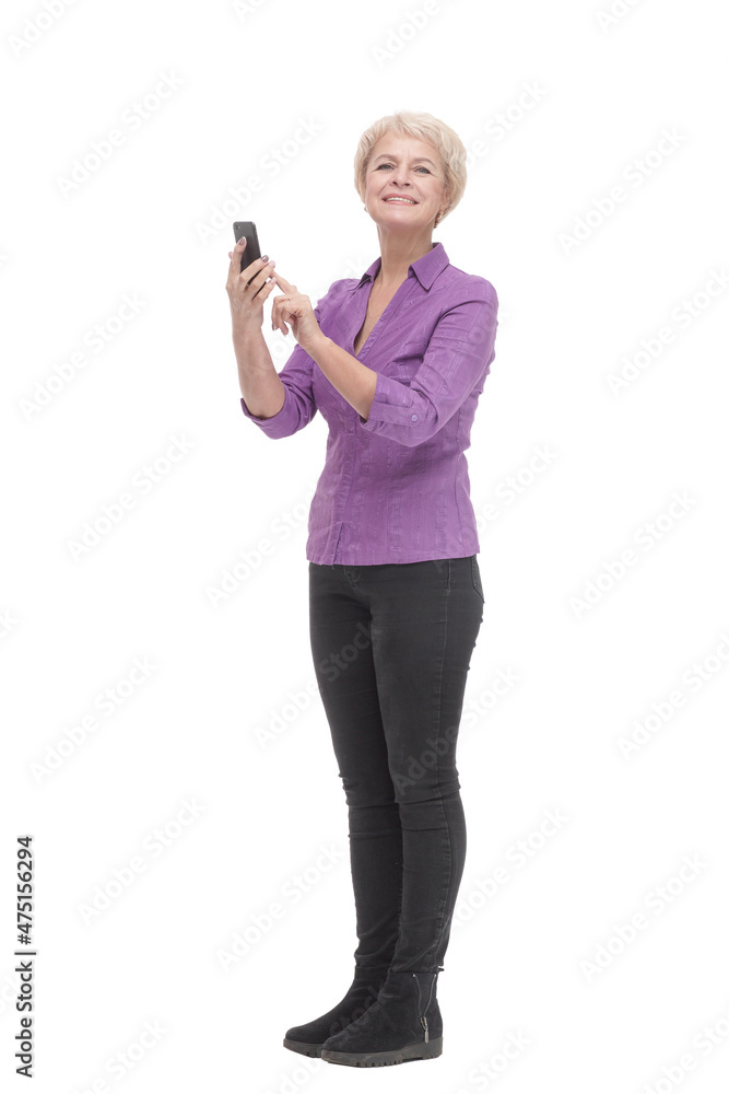 in full growth. smiling mature woman with a smartphone . in full growth. smiling mature woman with a smartphone .