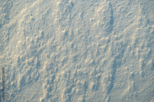 Uneven texture of snow in the sunset light