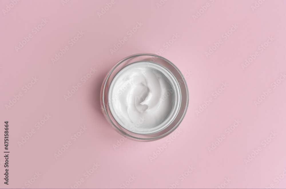 White cream jar on pink background close-up. Beauty cosmetics presentation. Moisturizing skincare product. Top view. Trendy healthcare concept. Copy space for design. Flat lay style White cream jar on pink background close-up. Beauty cosmetics presentation. Moisturizing skincare product. Top view. Trendy healthcare concept. Copy space for design. Flat lay style