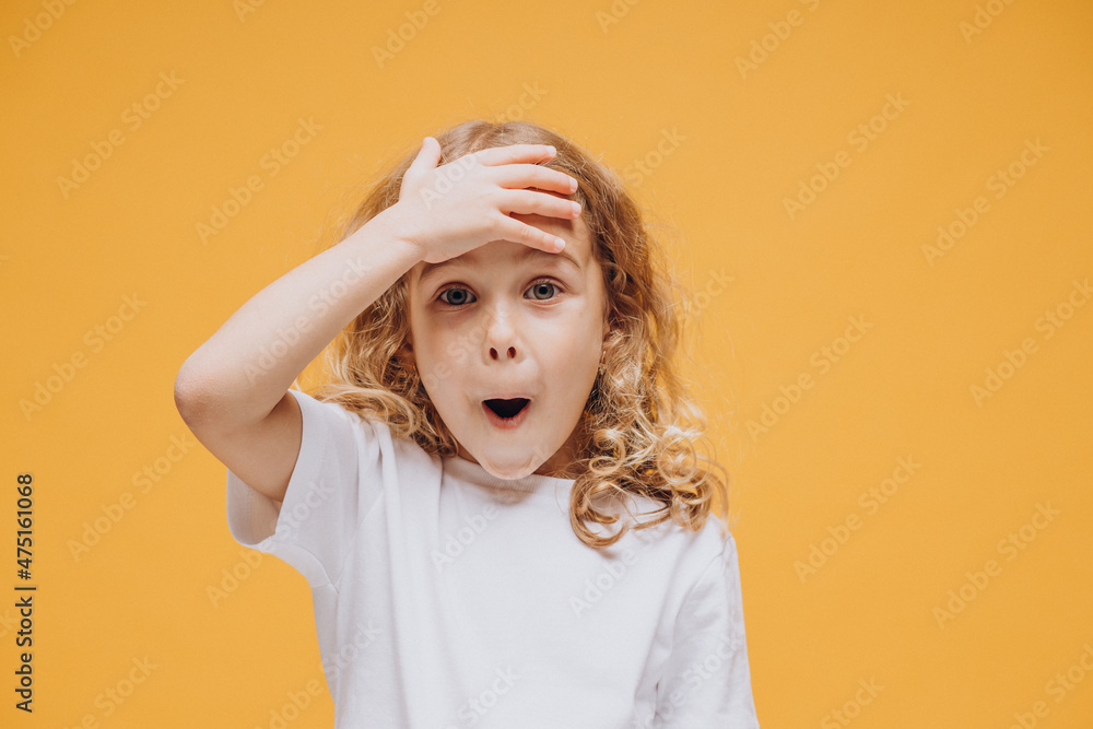 Cute little girl showing emotions, isolated on yellow background Cute little girl showing emotions, isolated on yellow background