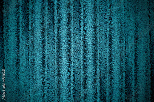 Wavy blue aluminum sheet with dark grunge texture for background