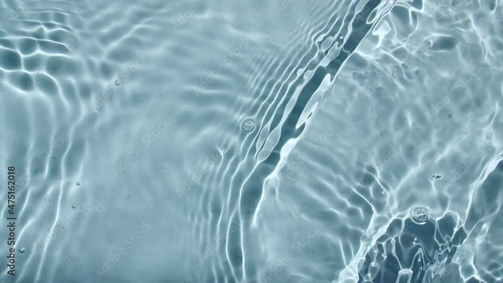Water surface texture top view. Water splash blue colored. Pure blue water with reflections sunlight in slow motion. Sun and shadows. Motion clean swimming pool ripples and wave. 4k. High quality Water surface texture top view. Water splash blue colored. Pure blue water with reflections sunlight in slow motion. Sun and shadows. Motion clean swimming pool ripples and wave. 4k. High quality