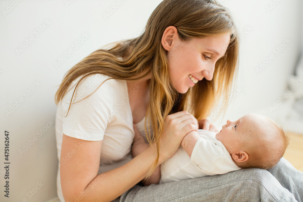 Happy young mother with her newborn baby at home. Happy young mother with her newborn baby at home.