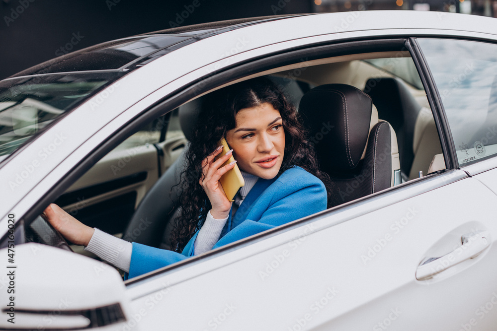 Woman sitting in car and using mobile phone Woman sitting in car and using mobile phone