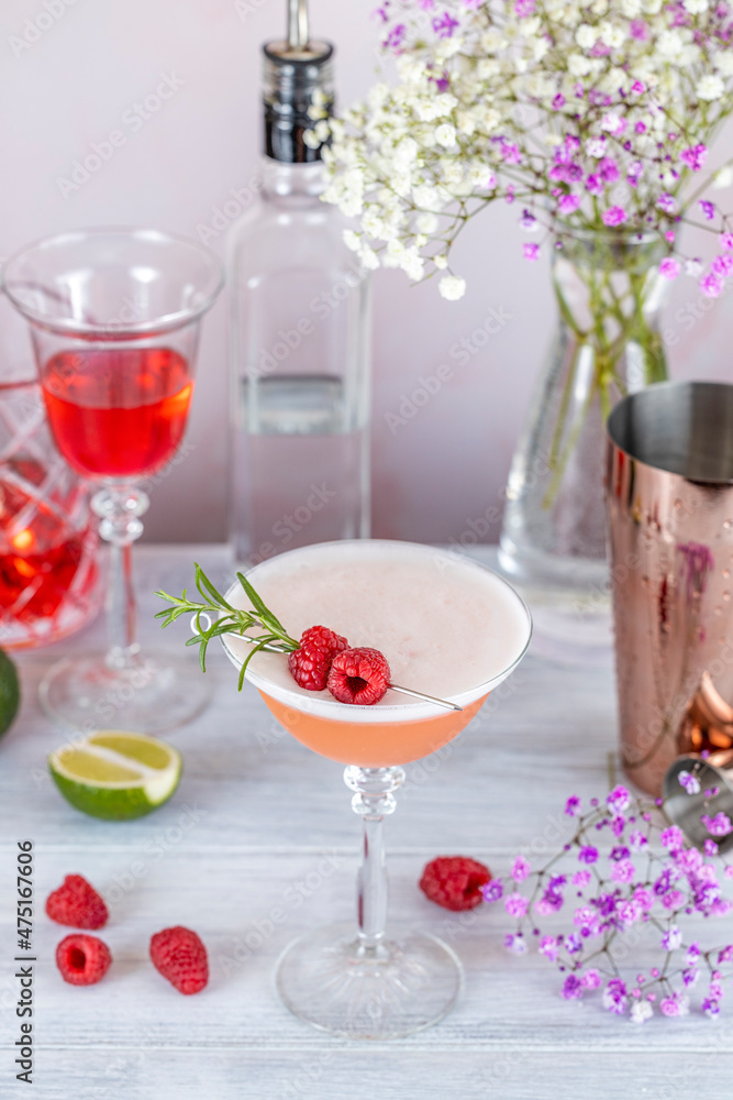 Clover Club Cocktail, a sour drink with Gin, raspberries, and egg white foam on light concrete surface. All day cocktail. Clover Club Cocktail, a sour drink with Gin, raspberries, and egg white foam on light concrete surface. All day cocktail.