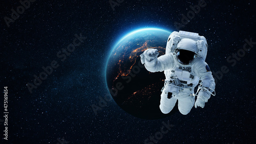 Astronaut in deep space with stars and blue planet earth. Space man in space