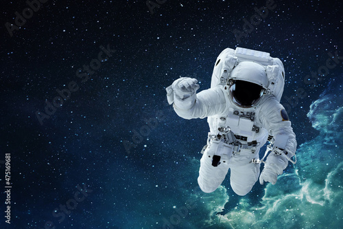 Spaceman astronaut with hamlet flying in blue deep space with stars.