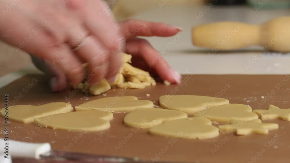 The woman works with the rolled dough. Cuts the dough into heart-shaped pieces. Prepares marshmallow sandwiches. Close-up shot. The woman works with the rolled dough. Cuts the dough into heart-shaped pieces. Prepares marshmallow sandwiches. Close-up shot.
