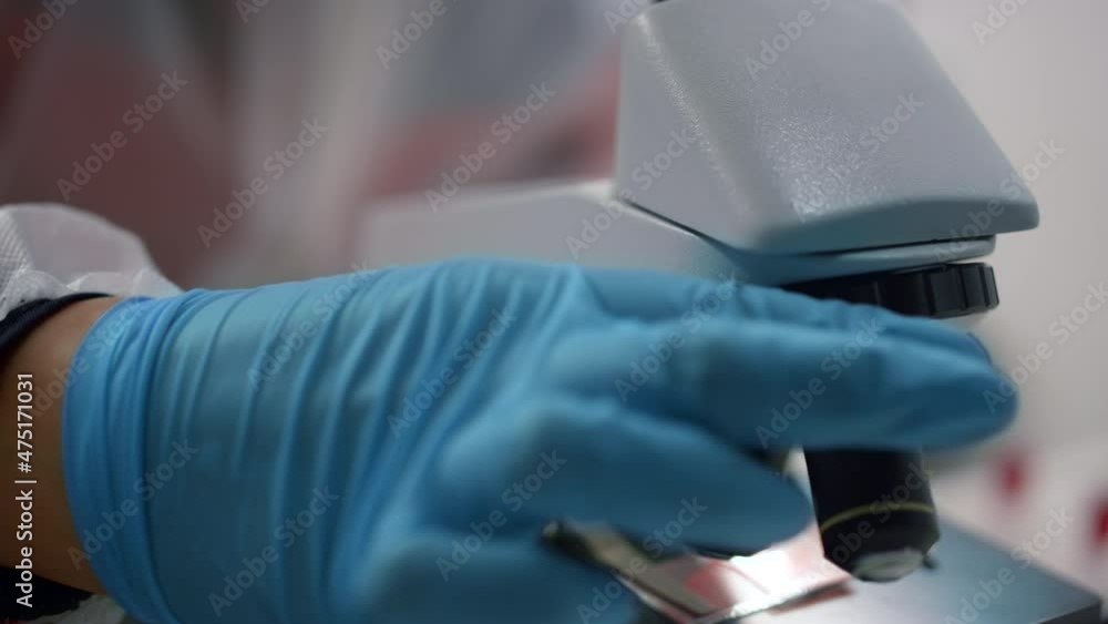 Scientist hand using microscope in laboratory. Researcher working with ...