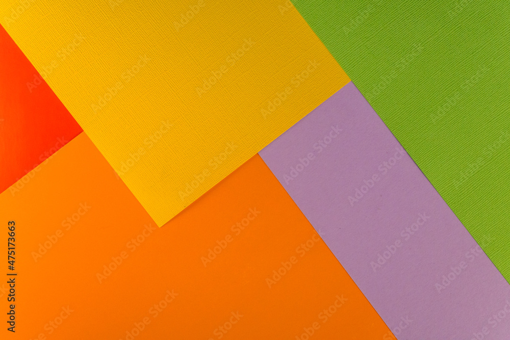 Bright abstract geometric paper background. Green, violet, yellow, red and orange trendy colors. The backdrop for an invitation card, greeting card or web design. Creative copy space, flat lay Bright abstract geometric paper background. Green, violet, yellow, red and orange trendy colors. The backdrop for an invitation card, greeting card or web design. Creative copy space, flat lay