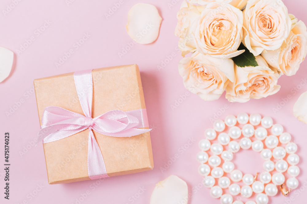 Festive flat lay with gift box, pearl necklace and roses Festive flat lay with gift box, pearl necklace and roses