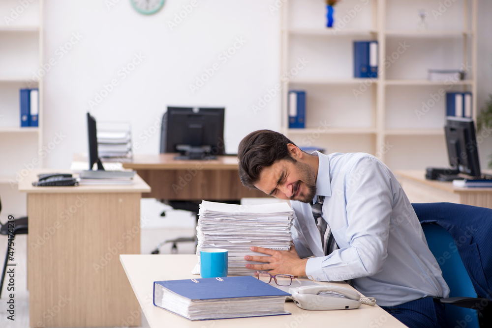 Young male employee working in the office Young male employee working in the office