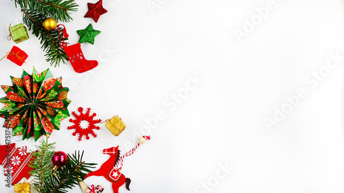 Christmas layout on a white background. Red, green and gold Christmas tree decorations, decor, gifts. Top view, copy space