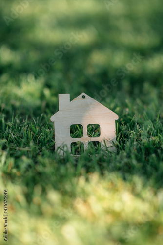 figurine house on green grass, concept of real estate services