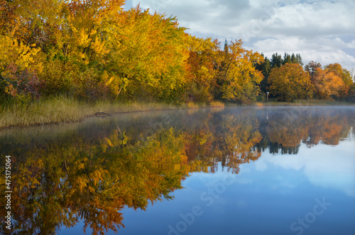 autumn trees reflected in water on beautiful autumn day in Minnesota USA
