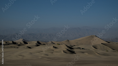 Εκτύπωση καμβά Sand dunes at the desert oasis of huacachina tourists take pictures and ride drive dune buggy sand board with guides before staying the night
