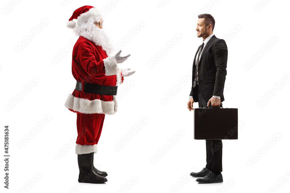 Full length profile shot of santa claus talking to a young businessman with a briefcase Full length profile shot of santa claus talking to a young businessman with a briefcase
