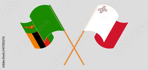 Crossed and waving flags of Zambia and Malta
