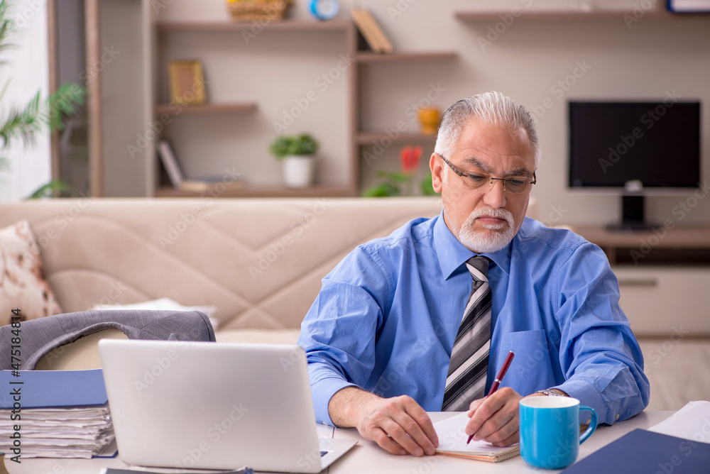 Old male employee working from home during pandemic Old male employee working from home during pandemic