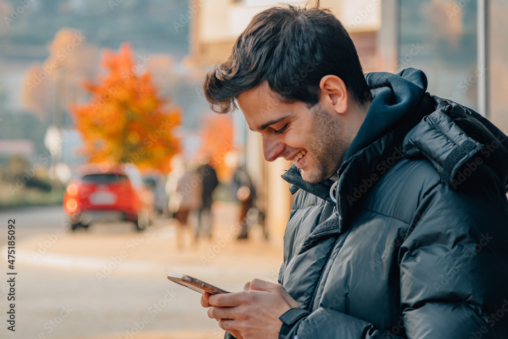 young man with mobile phone on the street young man with mobile phone on the street