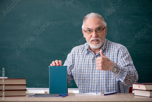 Old male teacher in the classroom