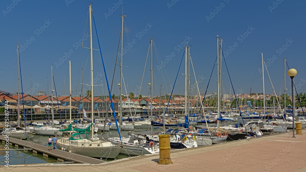 Sailboats in a dock of Belem Marina on a sunny summer day with clear blue sky, Lisbon, Portugal
