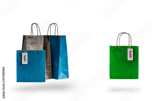 Set of multicolored shopping bags on a white isolated background. Sale and discounts 10, 20, 30, 40 ,50. Packages float in the air, casting a shadow