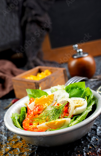 Fototapeta Naklejka Na Ścianę i Meble -  Salad with boiled egg, pepper, arugula and corn