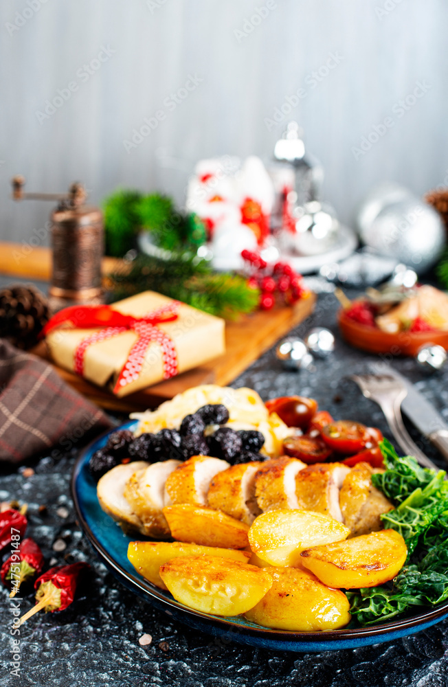 baked chicken breast with potatoes and olives on xmas background baked chicken breast with potatoes and olives on xmas background