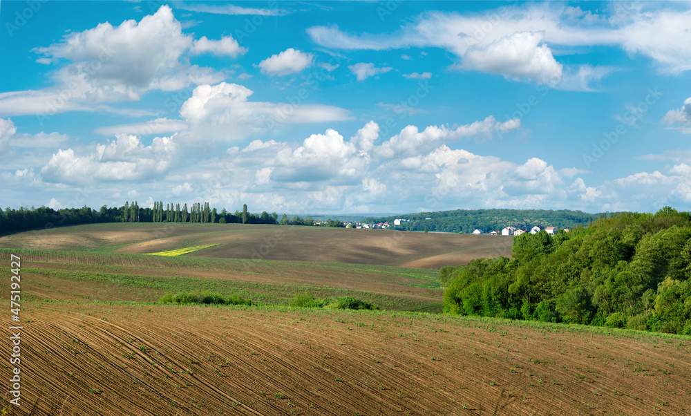 Plowed field and hills in a rural landscape at spring