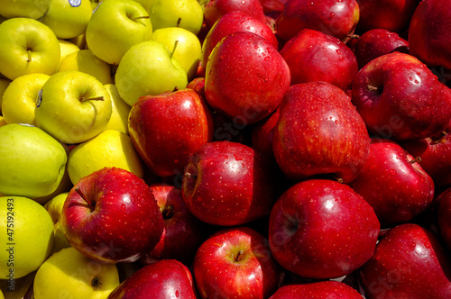 red and golden delicious in a market stall in the street