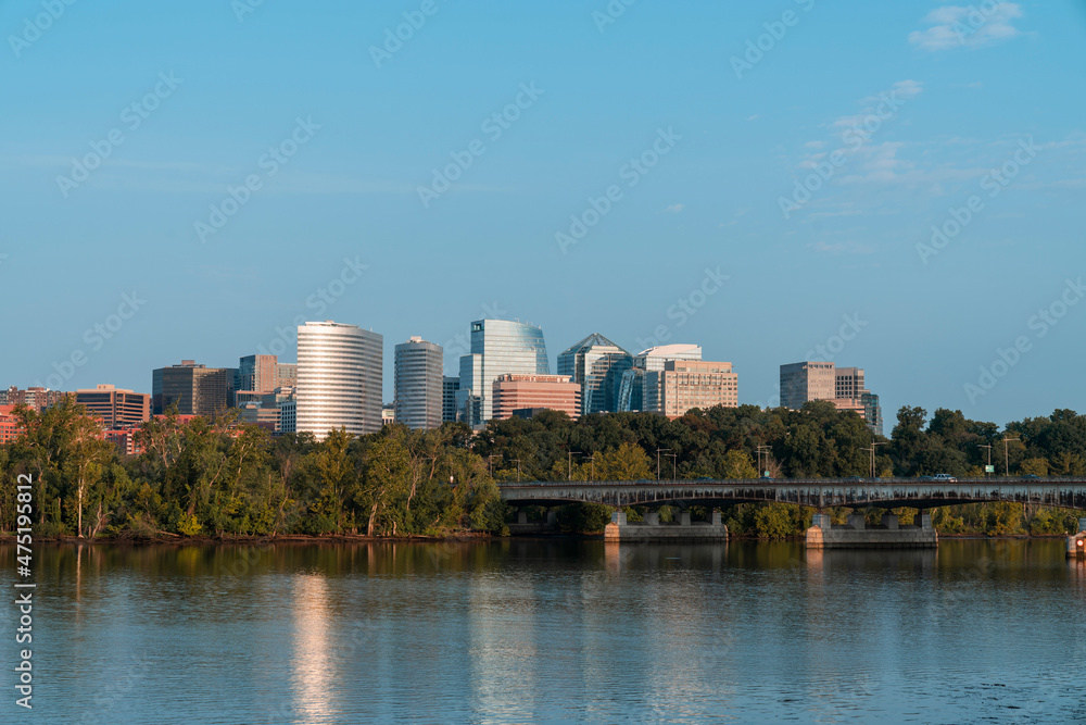 Panoramic view from Washington towards Arlington financial downtown city skyline at sunrise over the Potomac River. Virginia, USA. Business building facades as a concept of prosperous career.