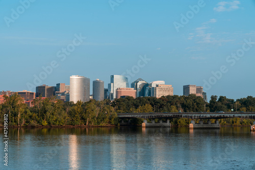 Panoramic view from Washington towards Arlington financial downtown city skyline at sunrise over the Potomac River. Virginia, USA. Business building facades as a concept of prosperous career.