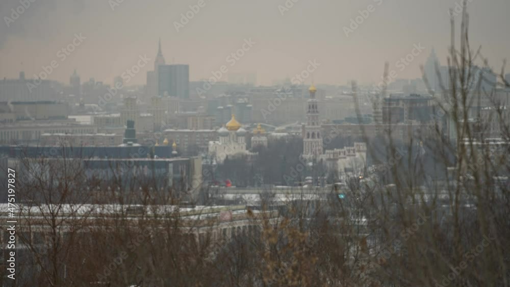 A winter cityscape in which two trains intersect. Two trains go in the city. Selective focus A winter cityscape in which two trains intersect. Two trains go in the city. Selective focus