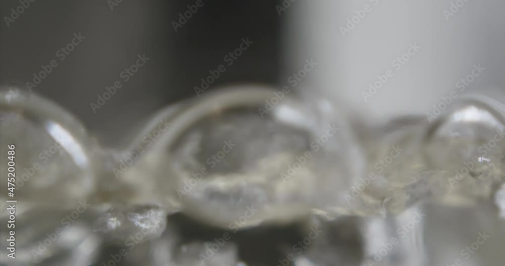 Close-up of boiling water in transparent glass container. Seething clear liquid Close-up of boiling water in transparent glass container. Seething clear liquid