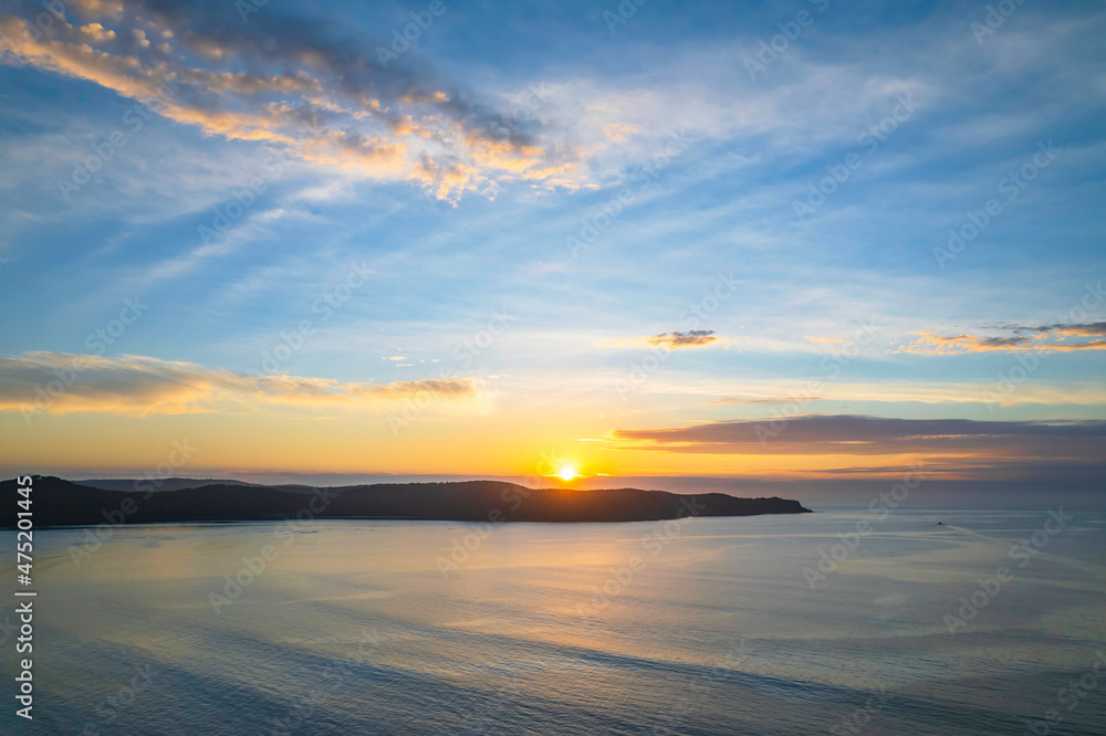 Sunrise seascape with a mix of high and medium clouds