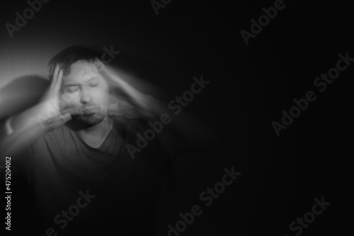 Blurred male portrait in the dark. Male portrait in motion in the dark. 