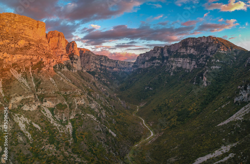 Aerial panoramic view of the impressive Vikos gorge in the Zagoria region at Pindus Mountains of northern Greece. It lies on the southern slopes of Mount Tymfi and it is the the deepest in Europe. © panosk18