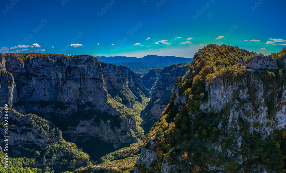 Fototapeta premium Aerial panoramic view of the impressive Vikos gorge in the Zagoria region at Pindus Mountains of northern Greece. It lies on the southern slopes of Mount Tymfi and it is the the deepest in Europe.