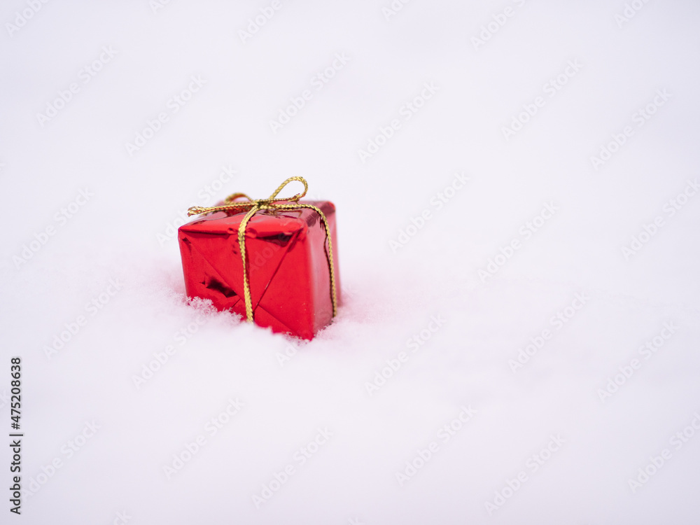 Red christmas present on the snow. Gift, Present. Merry christmas, handing a gift, joy Red christmas present on the snow. Gift, Present. Merry christmas, handing a gift, joy