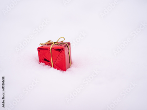 Red christmas present on the snow. Gift, Present. Merry christmas, handing a gift, joy