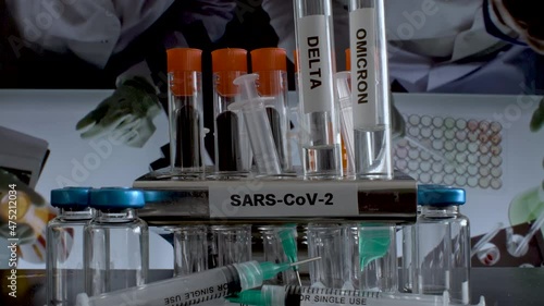 SARS COV 2 Test Tubes Labelled Alpha Gamma Delta Beta And Omicron Variants Being Removed From Rack In Working Laboratory. photo