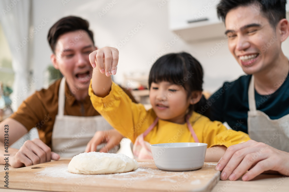 Asian attractive LGBTQ gay family teach girl kid making yeast dough. Asian attractive LGBTQ gay family teach girl kid making yeast dough.