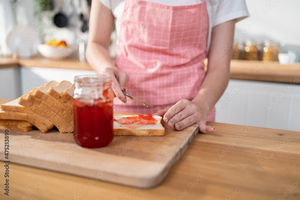 Close up of attractive woman making sandwich for breakfast in morning. Close up of attractive woman making sandwich for breakfast in morning.