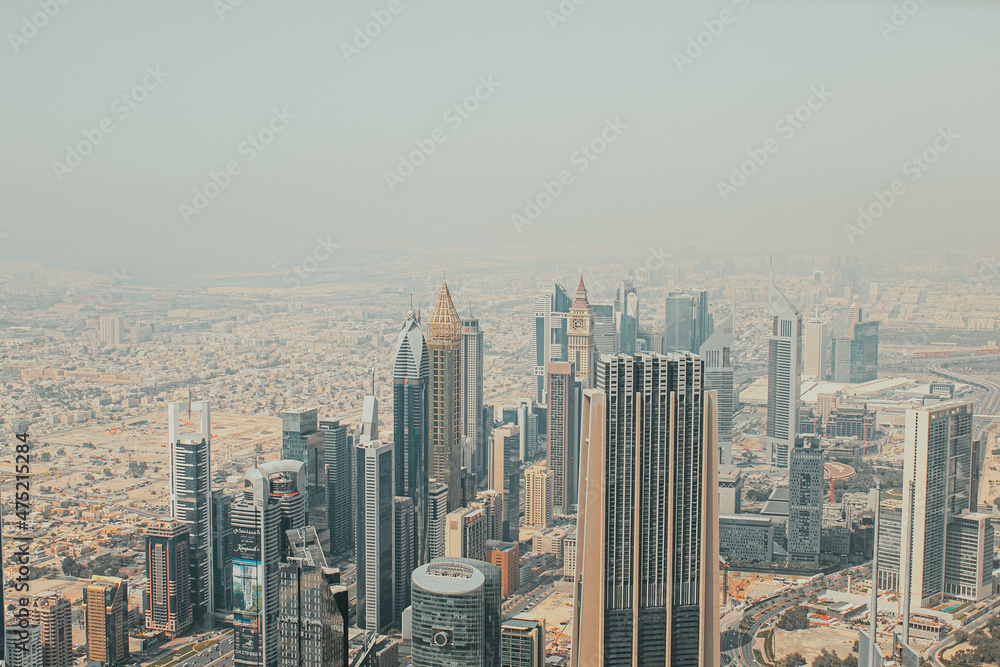Fototapeta premium View to skyscrapers and urban architecture of Dubai downtown and Financial Center area from a high building