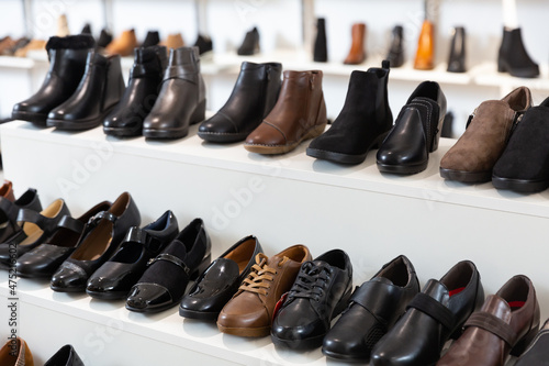 Woman shoes diversity at shelves of apparel shop
