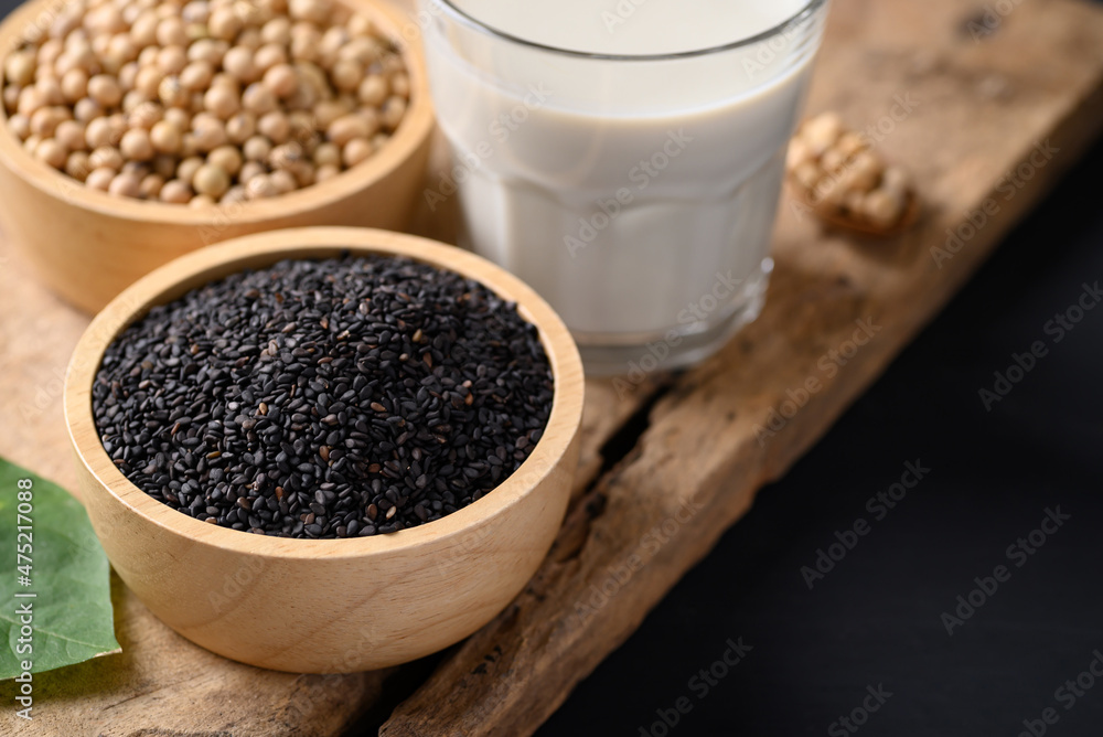 Soy milk and black sesame on wooden with black background, Healthy drink