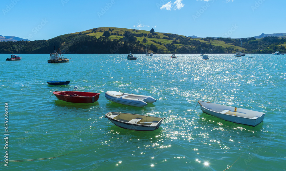 Dinghy and Boats at Akaroa Beach on the Banks Peninsula, southeast of Christchurch, South Island, New Zealand Dinghy and Boats at Akaroa Beach on the Banks Peninsula, southeast of Christchurch, South Island, New Zealand