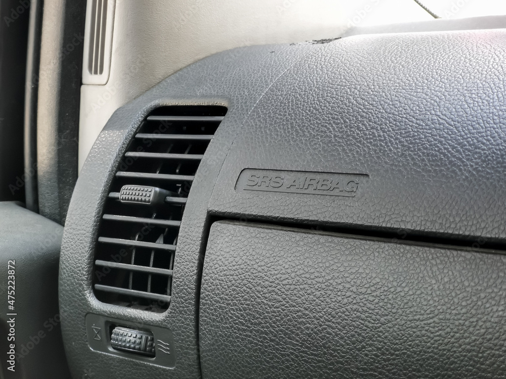 Car interior details. Car air conditioning vent and airbag icon on dashboard.